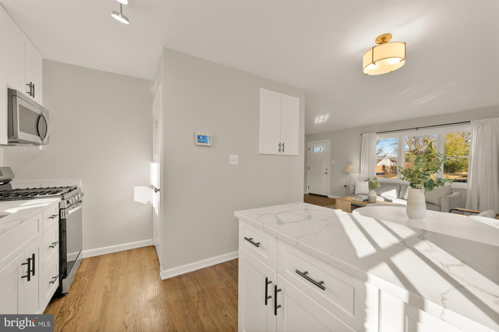 6112 Paulonia Road Alexandria, VA 22310 - Photo 18 of 48 a bedroom with a bed and a chandelier