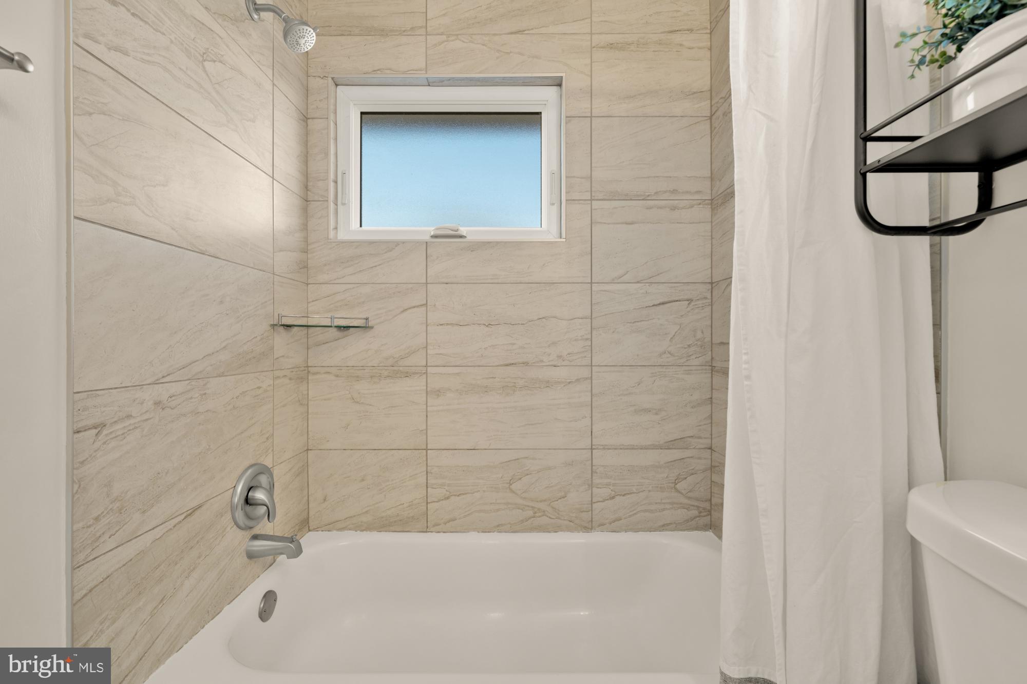 6112 Paulonia Road Alexandria, VA 22310 - Photo 31 of 48 a bathroom with a white bath tub and a shower