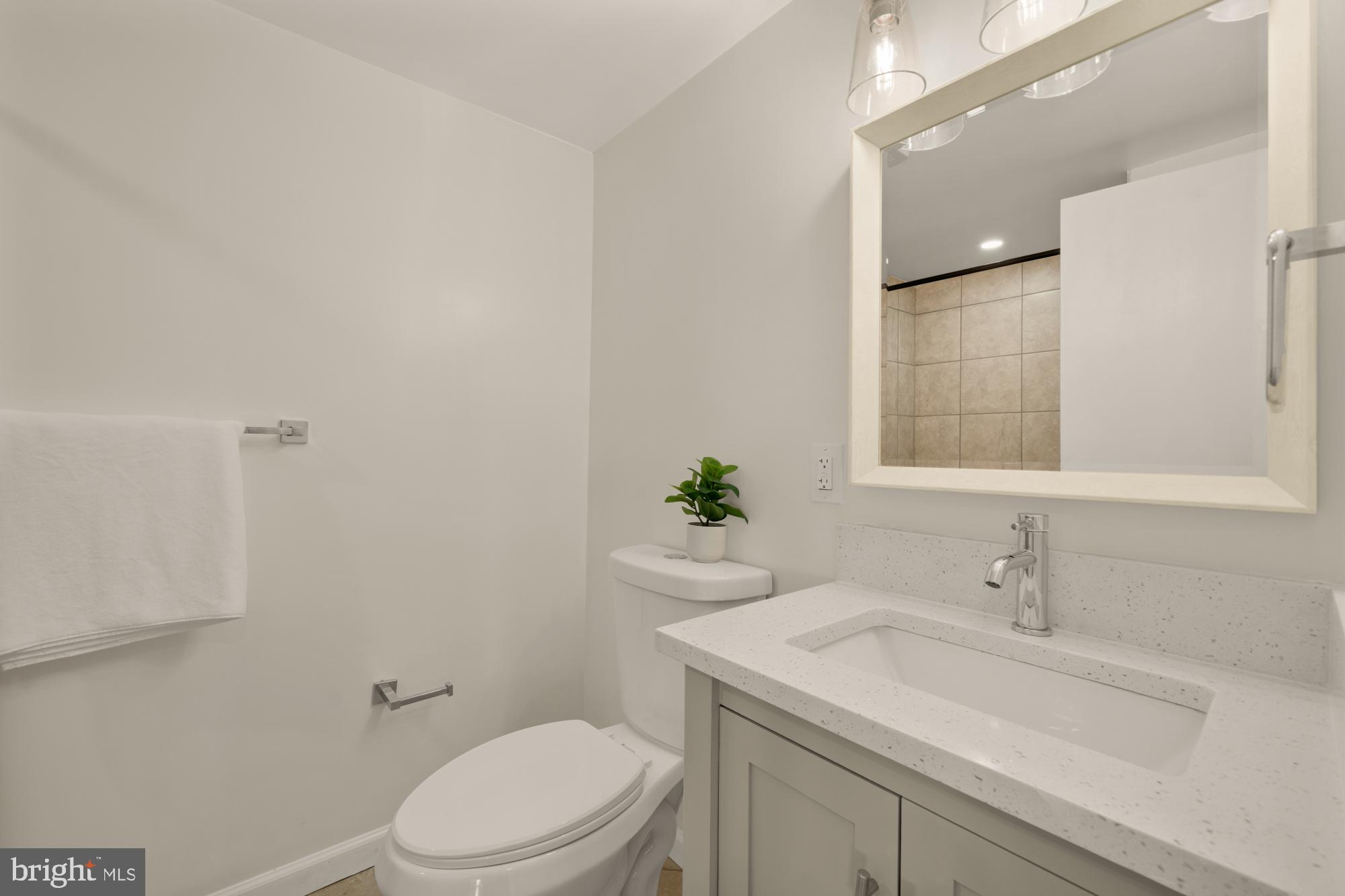 6112 Paulonia Road Alexandria, VA 22310 - Photo 39 of 48 a bathroom with a sink a toilet and a mirror