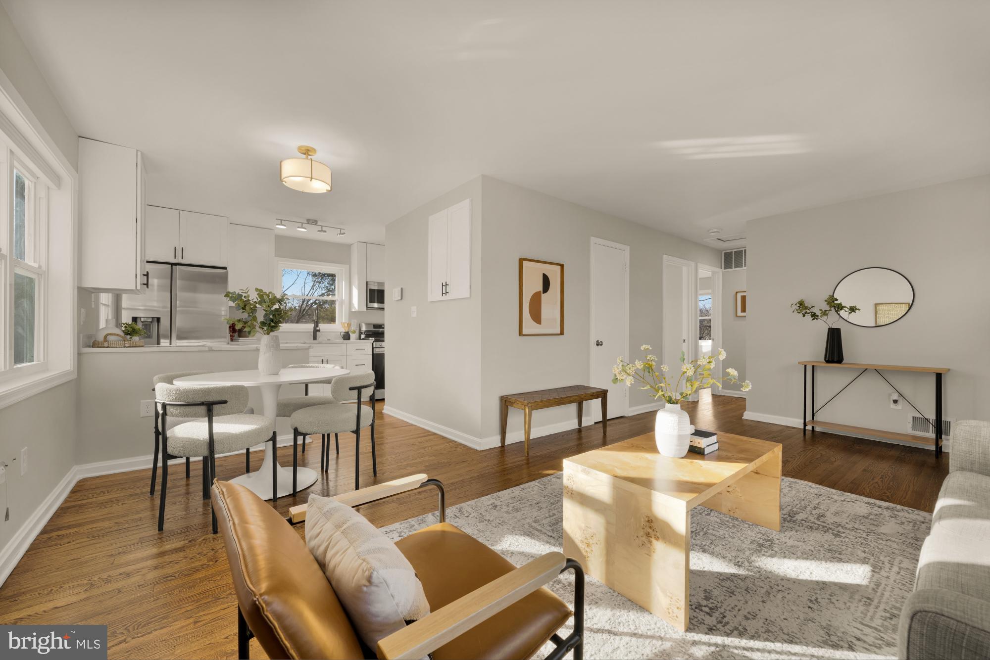 6112 Paulonia Road Alexandria, VA 22310 - Photo 10 of 48 a dining room with wooden floor a glass table and chairs