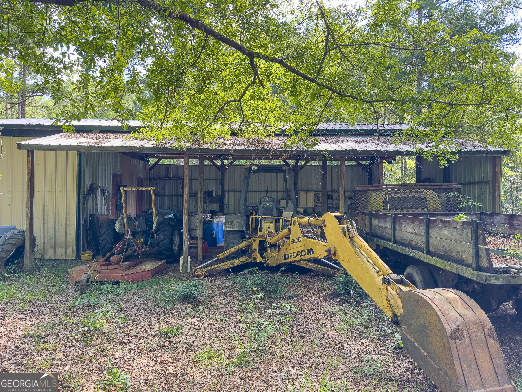583 Treisch Road Pineview, GA 31071 - Photo 30 of 53 a view of a backyard with a small pool and wooden fence