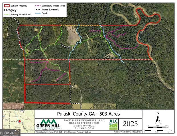 a view of a house with a lush green forest