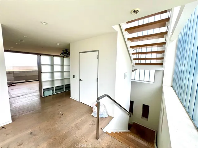 a view of a room with wooden floor