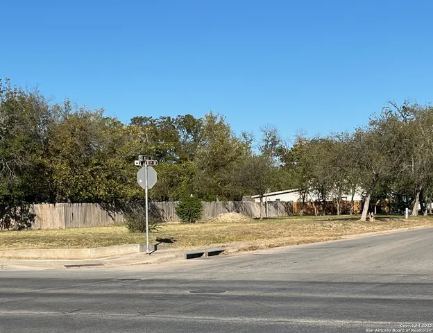 a view of a fountain is middle in the middle of a road