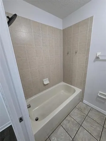 a bathroom with a tub a sink and a toilet