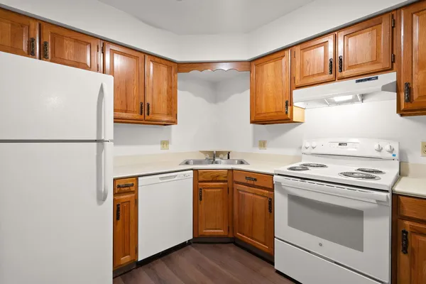 a kitchen with a stove cabinets and a refrigerator