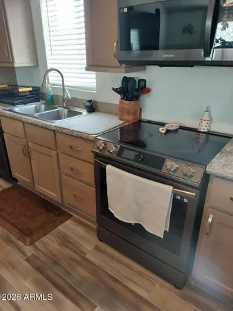 a stove top oven sitting inside of a kitchen
