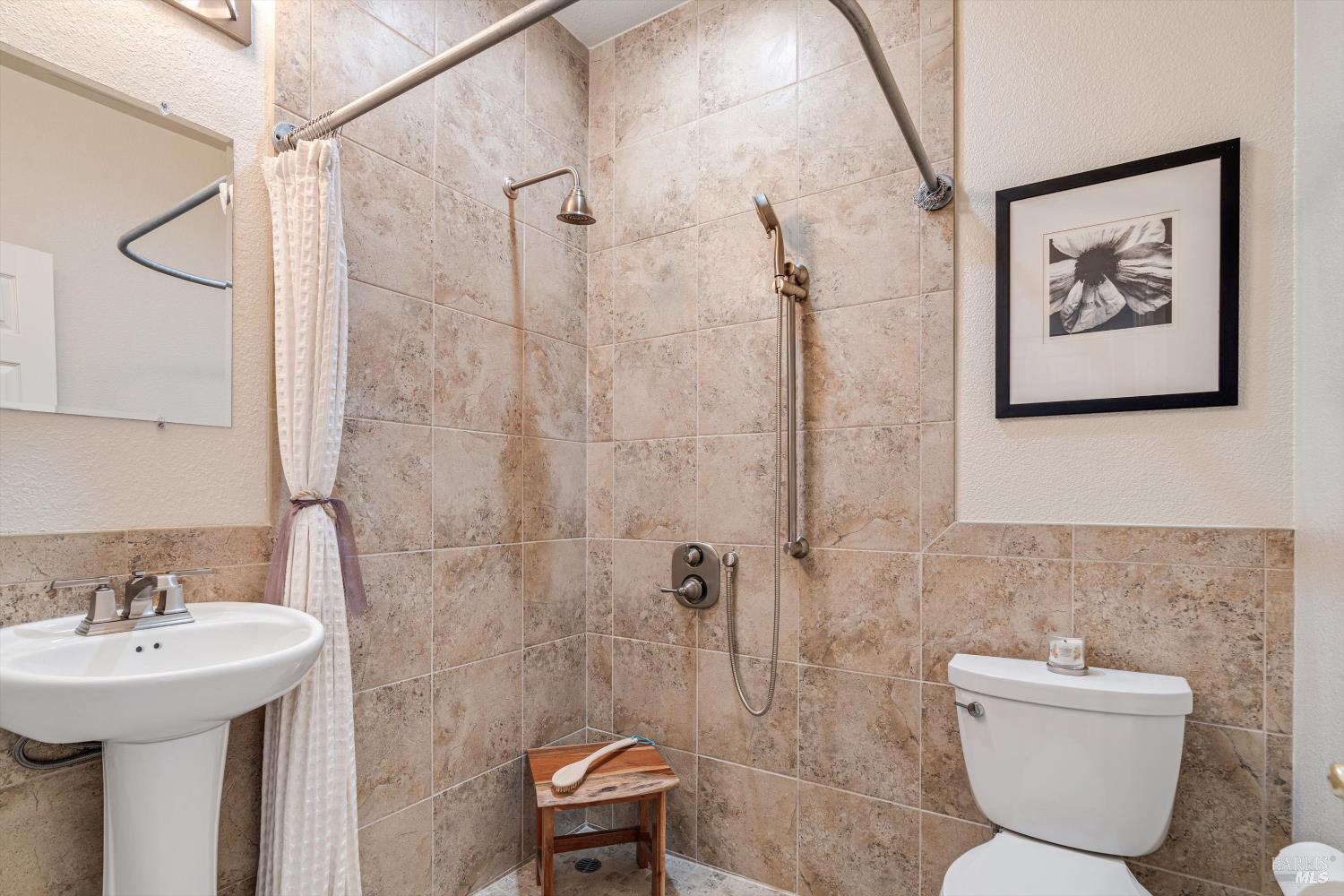 1703 Spur Ridge Lane Healdsburg, CA 95448 - Photo 11 of 28 a bathroom with a toilet sink and shower