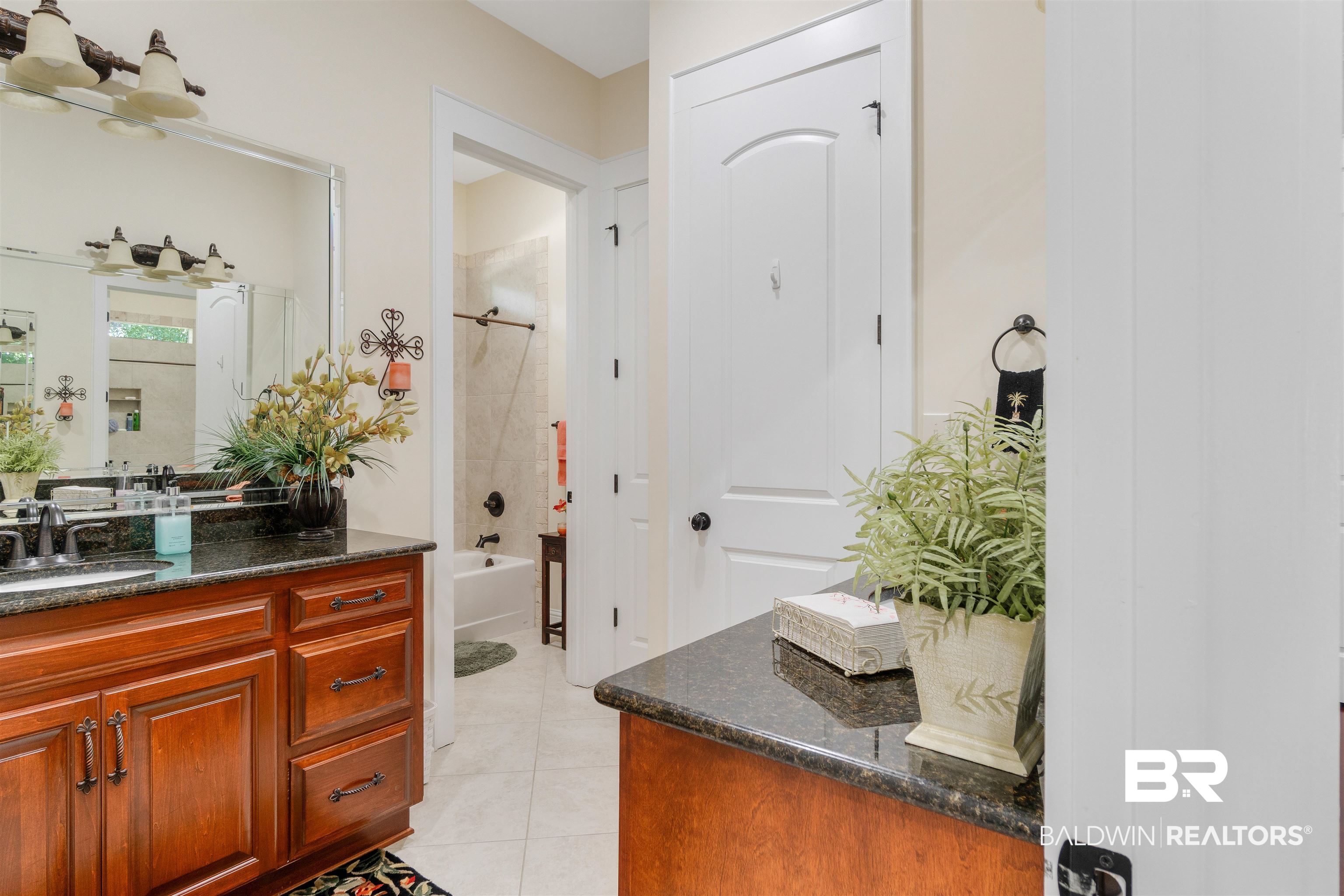 11281 Redfern Road Daphne, AL 36526 - Photo 49 of 80 Bathroom with tile patterned flooring, vanity, and tiled shower / bath combo