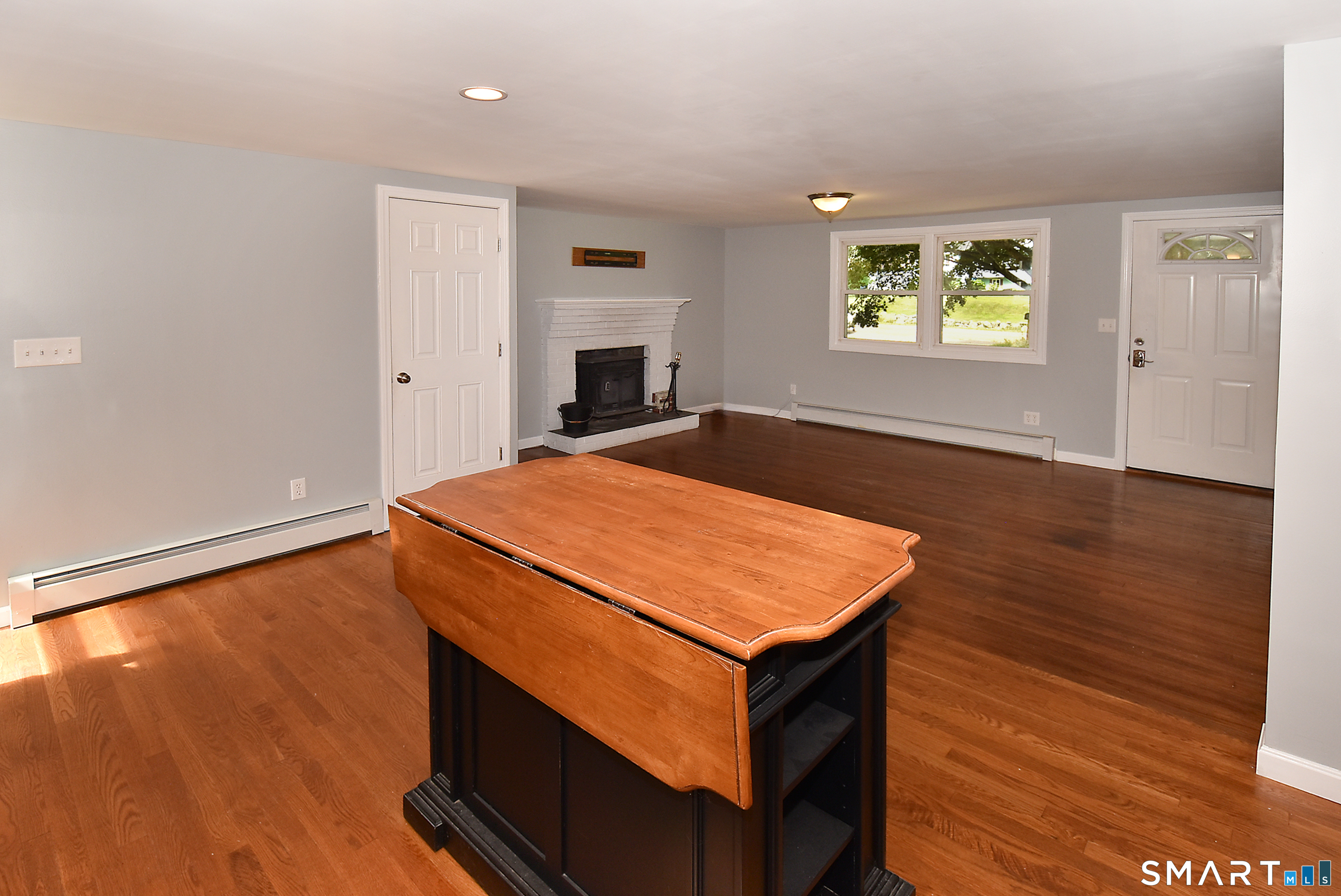 50 Doubleday Road Columbia, CT 06237 - Photo 10 of 29 The multi-purpose island with butcher block top folds up to allow for seating in the kitchen.