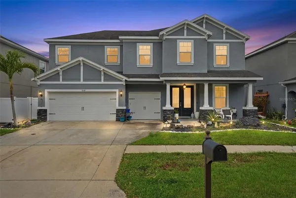 a front view of a house with swimming pool yard and patio