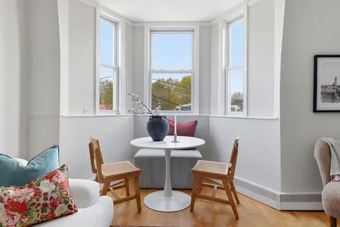 a dining room with furniture and window