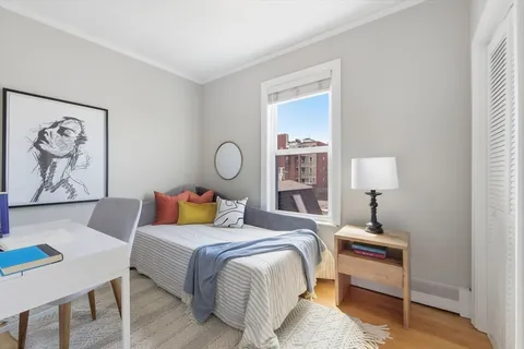 a bedroom with a bed and lamp