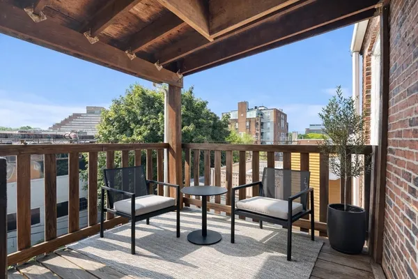 a view of a two chairs in the balcony