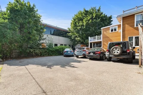 a view of a cars park in front of a building