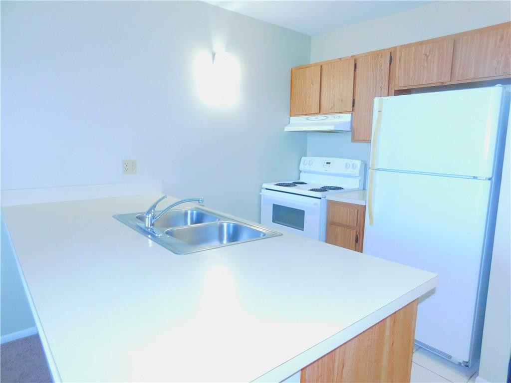 2501 Riverside Drive, Unit 506A Coral Springs, FL 33065 - Photo 2 of 11 a kitchen with a sink a stove and refrigerator