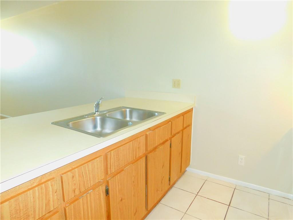 2501 Riverside Drive, Unit 506A Coral Springs, FL 33065 - Photo 3 of 11 a kitchen with a sink and cabinets