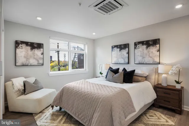 a bedroom with a bed and glass window