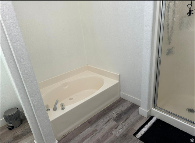 265 Mindella Way Layton, UT 84041 - Photo 25 of 32 Soaking tub with chrome fixtures, wood-finish flooring, and white baseboards