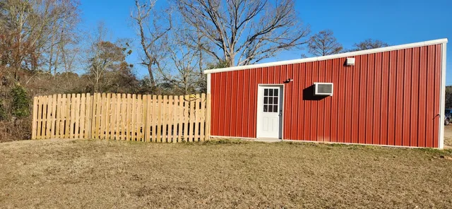 a view of a house with a wooden fence