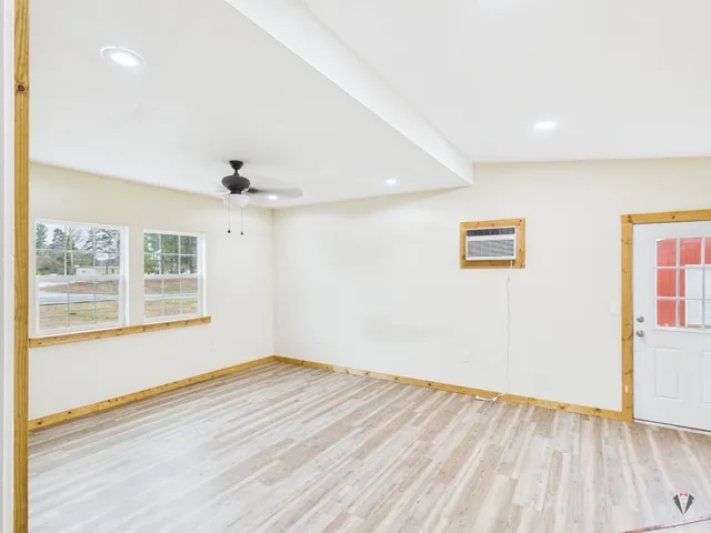 wooden floor in an empty room with a window