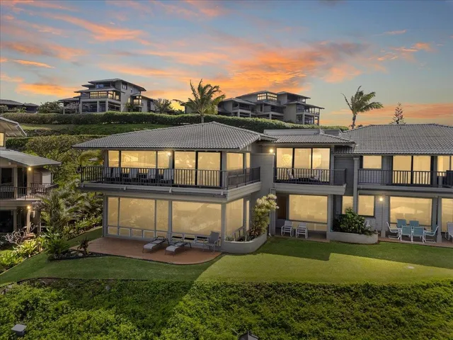 a view of a house with a big yard and a garden