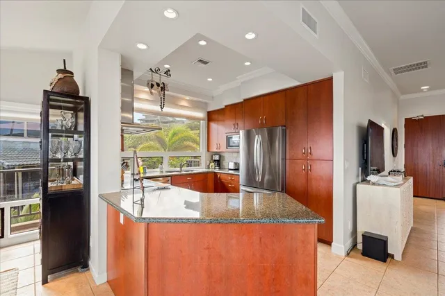 a kitchen with stainless steel appliances granite countertop a stove and a refrigerator