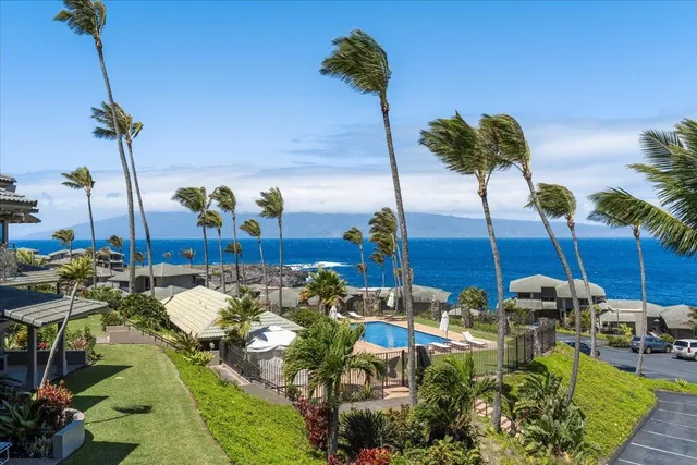 a bedroom with a bed a flat screen tv and a chandelier