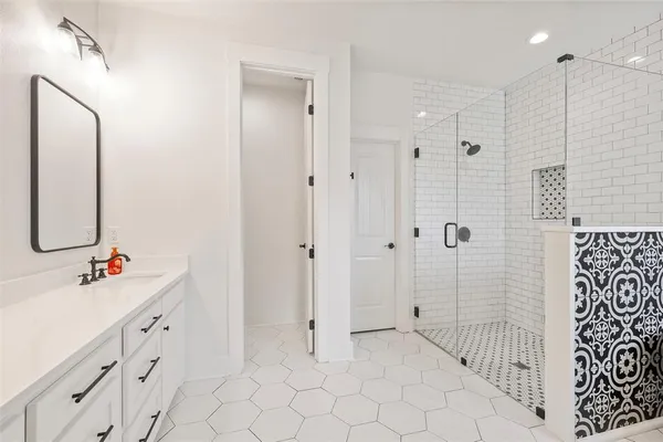 a spacious bathroom with a double vanity sink mirror and double