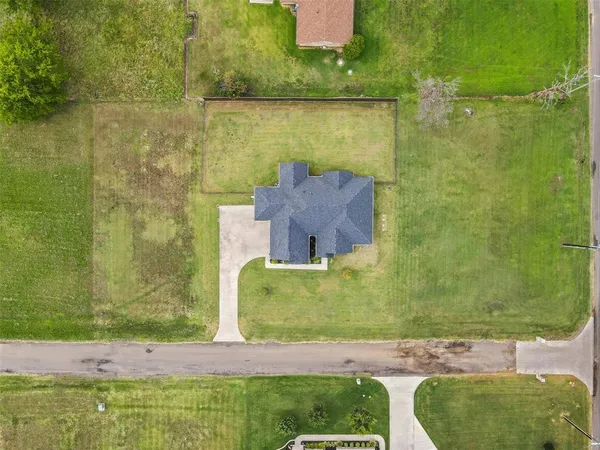 an aerial view of a house with a yard