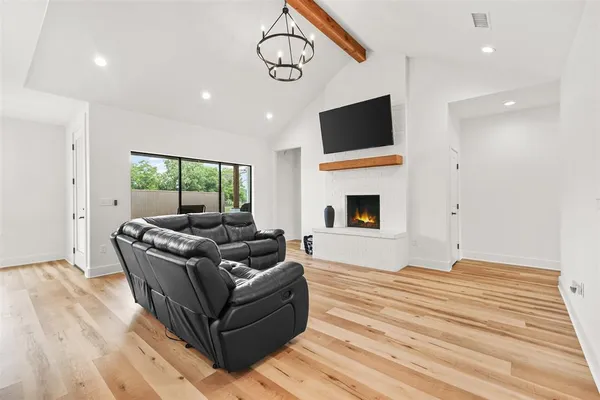 a living room with furniture flat screen tv and a fireplace