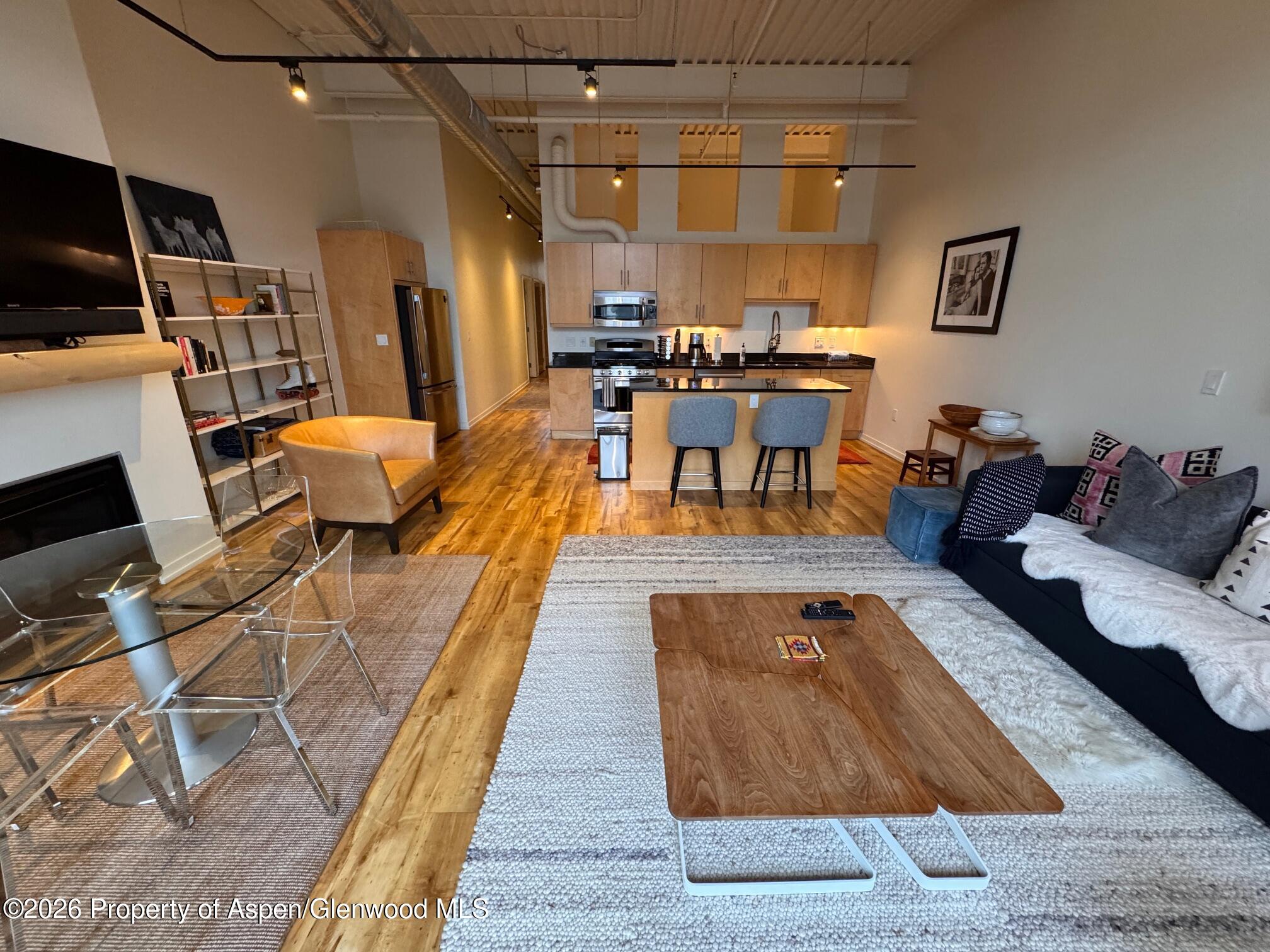 361 Robinson Street, Unit 232 Basalt, CO 81621 - Photo 4 of 26 a living room with lots of furniture and a view of kitchen