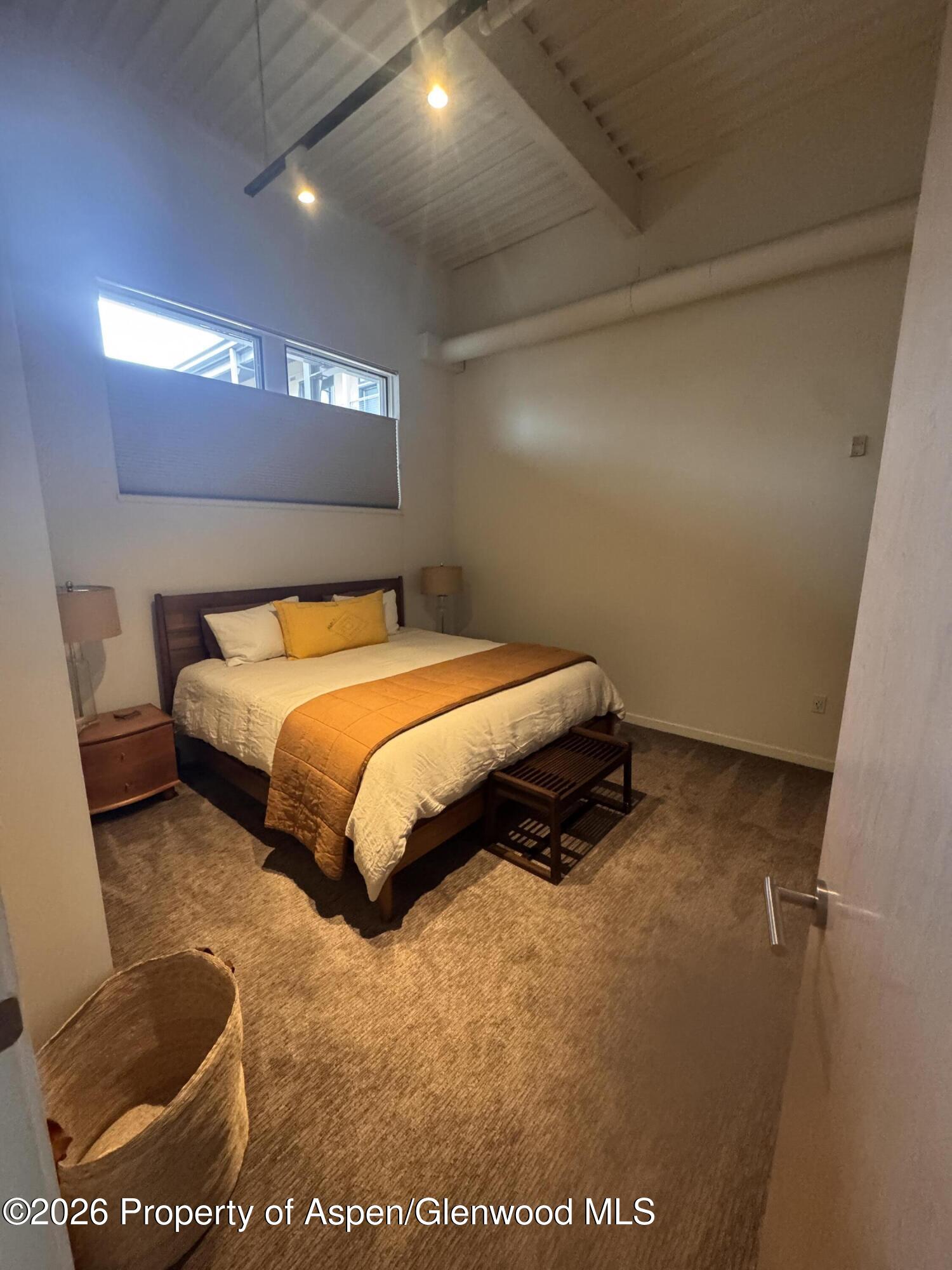 361 Robinson Street, Unit 232 Basalt, CO 81621 - Photo 7 of 26 a bedroom with a bed and a night stand