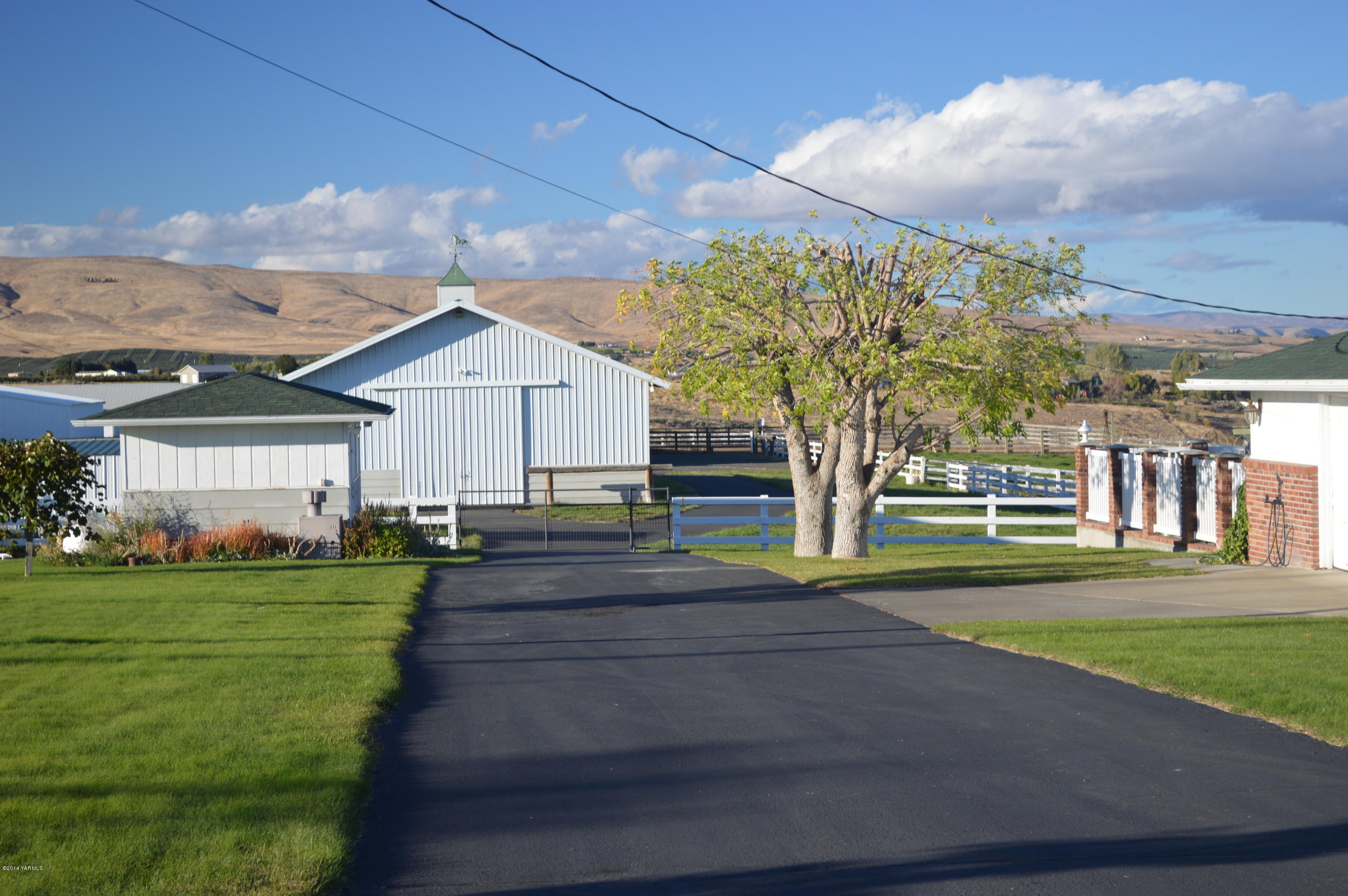 1051 Hubbard Road Yakima, WA 98903 - Photo 3 of 50 a front view of a house with garden and trees