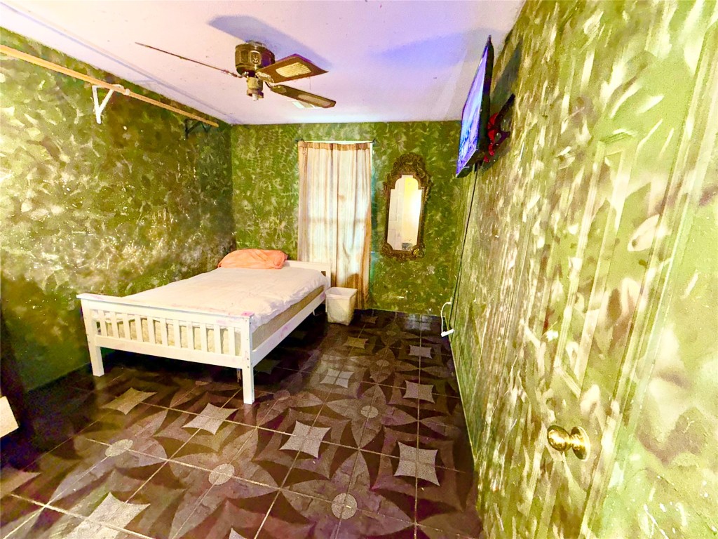 315 Gober Street Houston, TX 77017 - Photo 9 of 12 a bedroom with a bed and wooden floor