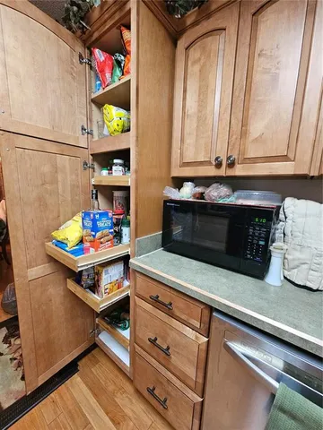 a bathroom with a sink a toilet a mirror and shower
