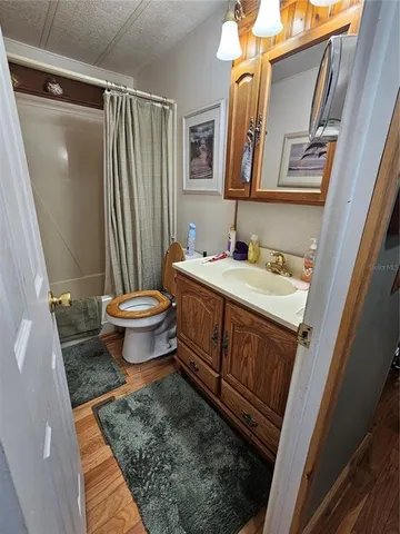 a view of a yard with wooden fence