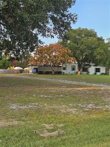 a view of living room with furniture and a mirror