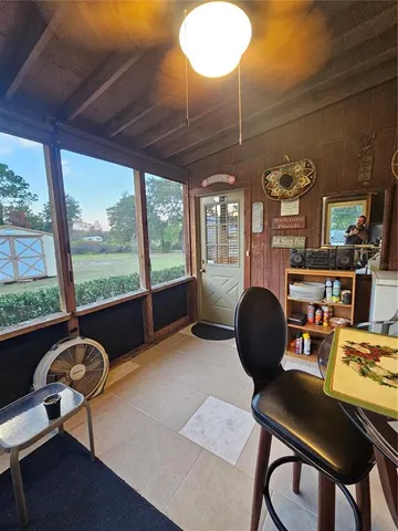 a living room with furniture a chandelier and a lamp