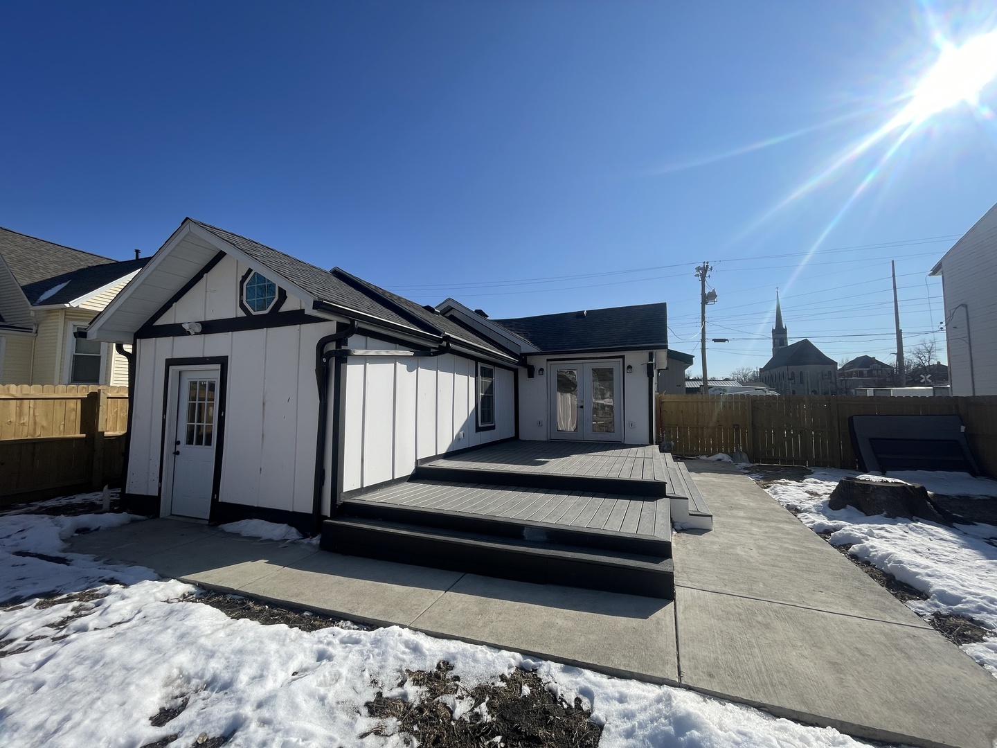 a view of house with backyard and furniture