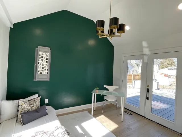 a bedroom with a bed and windows