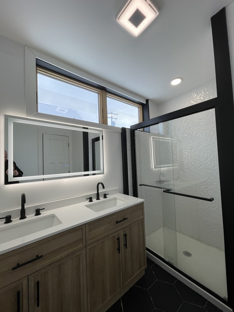607 West Olive Street Bloomington, IL 61701 - Photo 16 of 17 a bathroom with a double vanity sink mirror and shower