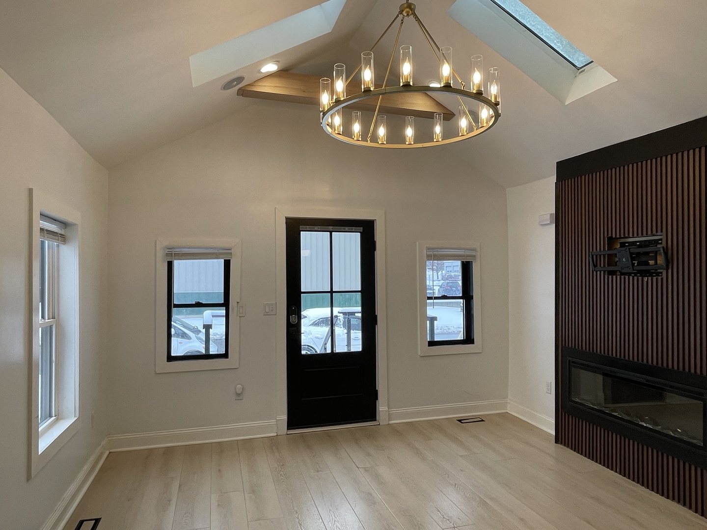 607 West Olive Street Bloomington, IL 61701 - Photo 7 of 17 an empty room with wooden floor chandelier and windows