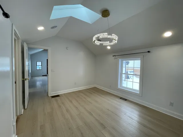 a view of walk in closet with empty racks