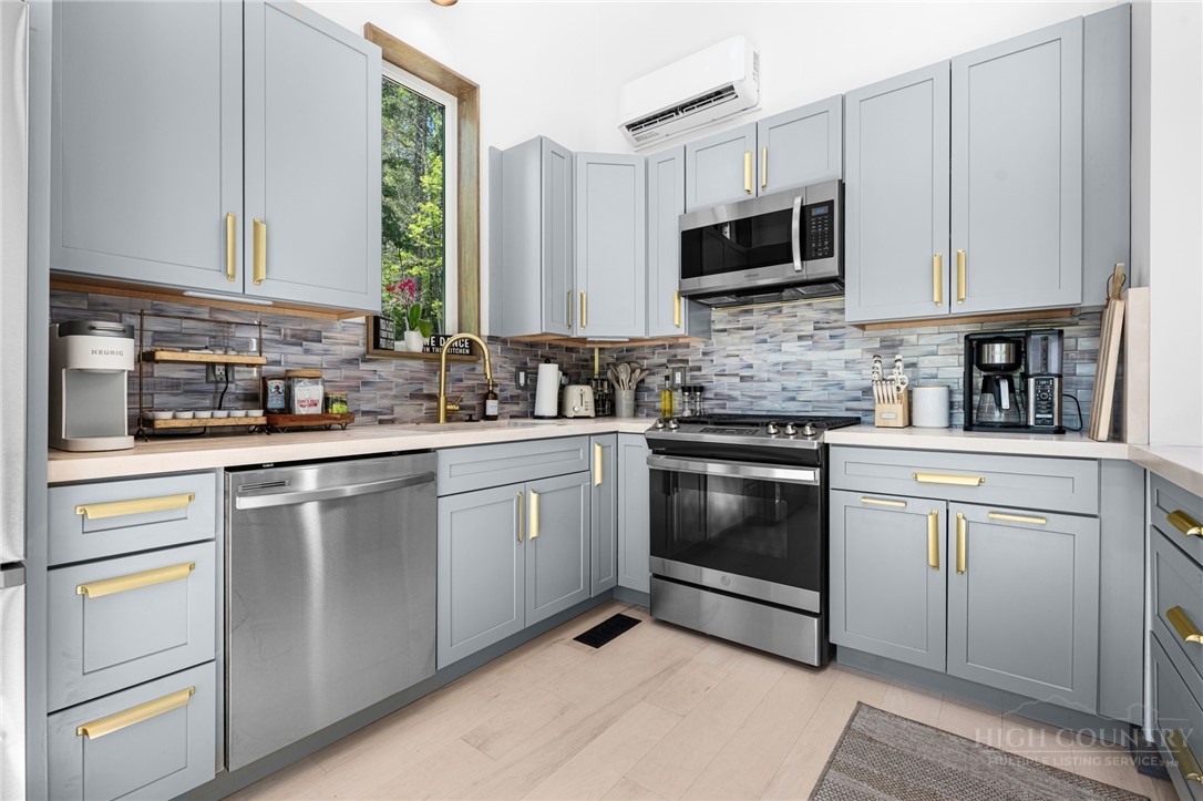 1385 Niley Cook Road Blowing Rock, NC 28605 - Photo 9 of 40 a kitchen with white cabinets appliances and a sink