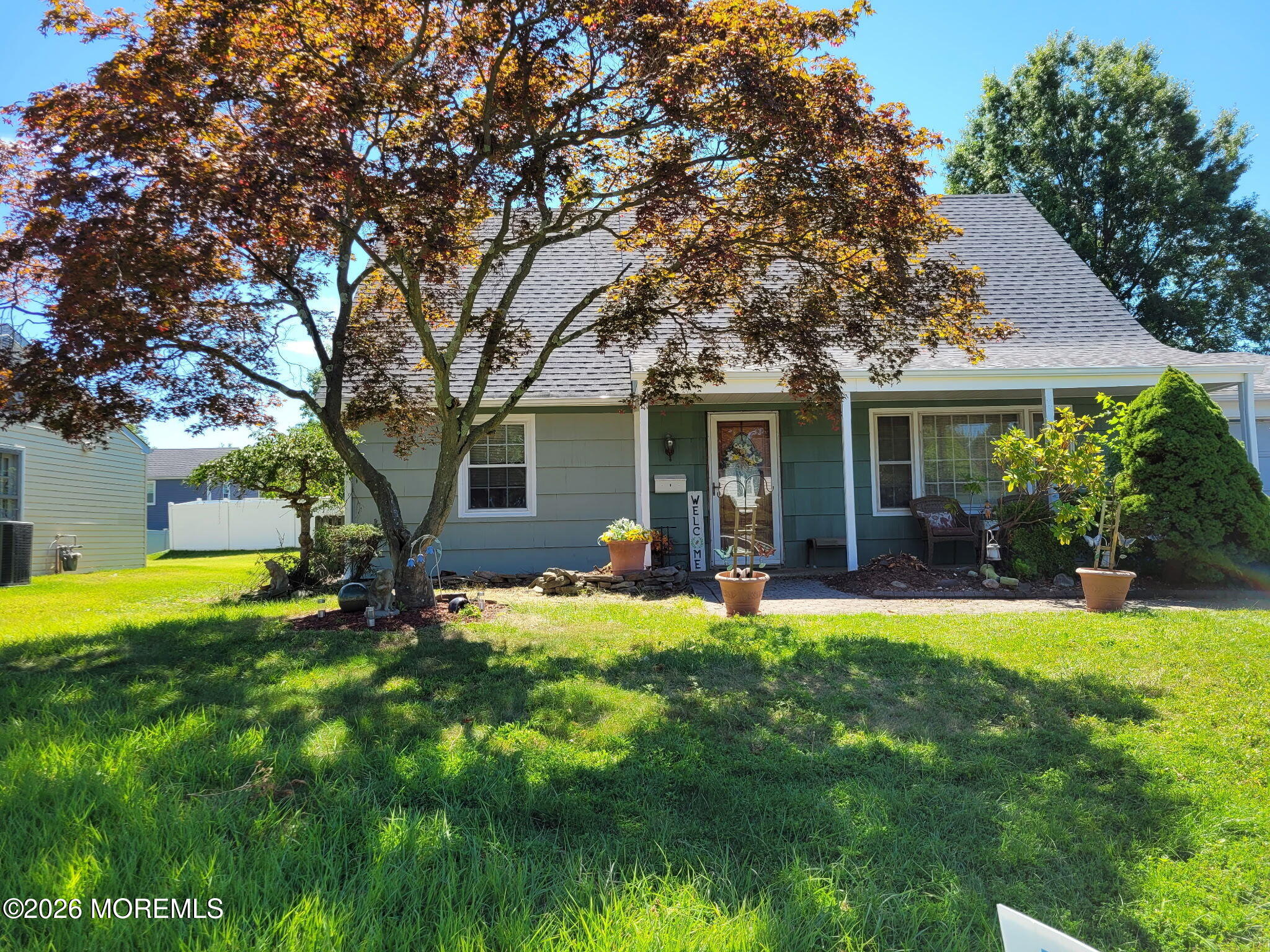 a front view of house with a garden and patio