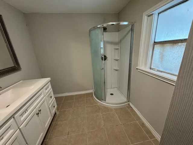 a bathroom with a shower and a sink