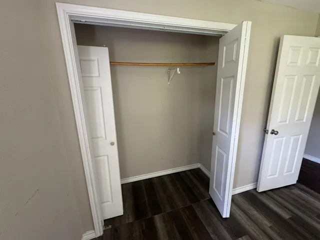 a view of a room with wooden floor and staircase