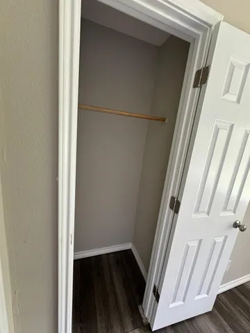 a view of a hallway with wooden floor and gate