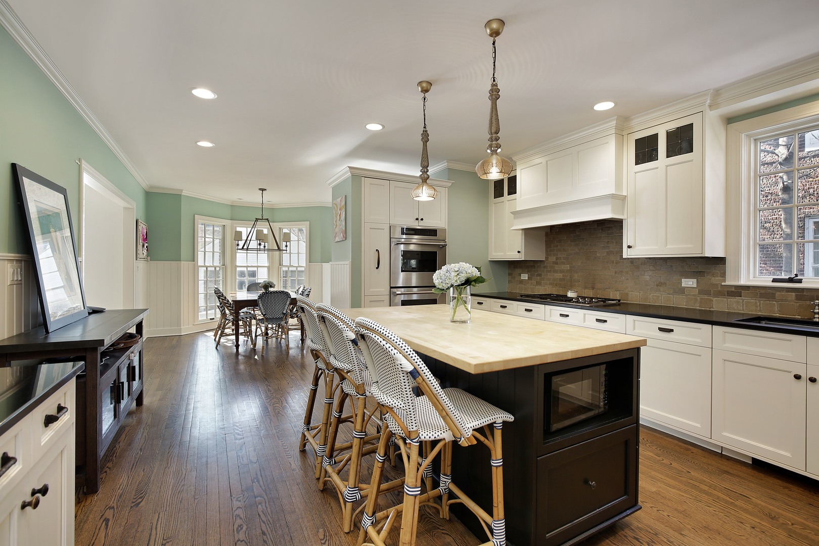 234 Raleigh Road Kenilworth, IL 60043 - Photo 8 of 29 a kitchen with stainless steel appliances granite countertop a stove a sink dishwasher a refrigerator with white cabinets and wooden floor